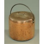 A large 19th century copper lidded vessel, with iron loop handle, diameter 40 cm.