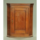 A George III oak hanging corner cupboard,