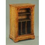 A Victorian walnut music cabinet, with glazed door opening to shelves and pigeonholes, width 58.