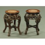 A near pair of Chinese carved hardwood jardiniere stands,