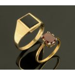 An 18 ct yellow gold dress ring, set with a garnet, and a 9 ct gold gentleman's ring.