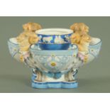 A KPM Berlin porcelain table centrepiece, late 19th century, of quatreform shape with rams masks,