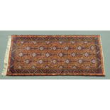 An Eastern rug. 92 cm x 201 cm including fringe.