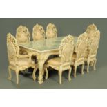 A large Italian rococo style white and gilt painted dining room suite, comprising sideboard,