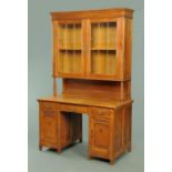 An Edwardian oak bookcase and combined desk,