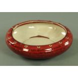 A Chinese Sang de Boeuf glazed bowl, Qing dynasty, of squat circular form,