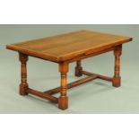 An oak Titchmarsh & Goodwin draw leaf dining table, Model No. RL19870/DT.