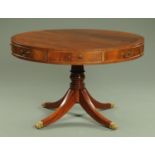 A Georgian style mahogany circular drum table, with four actual and four dummy drawers,