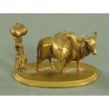 An Indian brass novelty figure of a female and ox, late 19th/early 20th century,