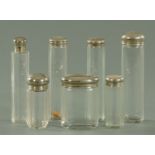 Seven 19th century faceted glass dressing table jars, with silver plated mounts. Tallest 17.5 cm.