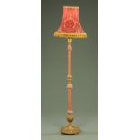 A giltwood and gesso lamp standard, partially fabric covered.
