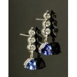 A pair of 18 ct white gold drop earrings, set with diamonds and trillion cut tanzanites,