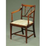 A Regency mahogany armchair, with slightly bowed top rail, shaped arms with turned supports,