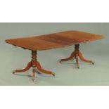 A George III mahogany twin pedestal dining table, comprising two ends and one leaf,
