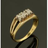 An 18 ct gold three stone diamond ring, size N/O, 4.4 grams gross.