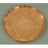 An Arts and Crafts period copper tray, in stylised foliate decoration and with crimped rim,