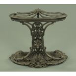 A Victorian style cast iron hall stick stand, shell moulded and with five apertures. Width 65 cm.