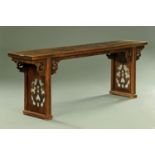 An antique elm Chinese altar table, with fretwork supports.