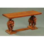A vintage coffee table, with carved elephant supports and low stretcher. Top 101 cm x 45.5 cm.