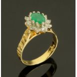 An 18 ct gold emerald and diamond cluster ring, size K/L, hallmarked.