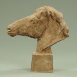A cast iron horse head raised on a square tapering base, height 58 cm.
