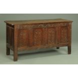 An 18th century carved oak blanket box, with moulded edge,