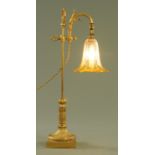 An Edwardian brass adjustable table lamp, with amber and clear glass shade.