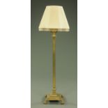 A brass telescopic standard lamp, with reeded oil lamp converted for electricity,