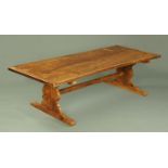 A large refectory table, with end supports and centre stretcher, 260 cm x 106 cm.