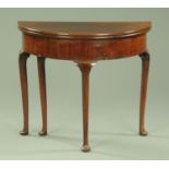 An early Georgian mahogany demi lune turnover top tea table,