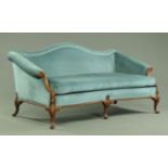 A George III style settee, with arched back and rollover arms,