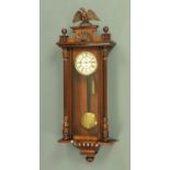 A Victorian single weight Vienna wall clock, with eagle surmount and turned and fluted pilasters,
