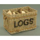 A log basket, with interior division and rope carrying handle to either side, width 78 cm,