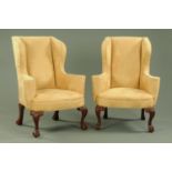 A pair of Queen Anne style wing armchairs,