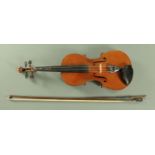 A full size violin, 20th century, with ebony finger board, and figured two piece back,