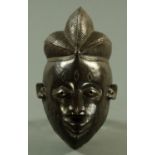 A Yoruba carved wood mask, 20th century,