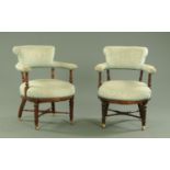 A pair of Edwardian mahogany tub armchairs.