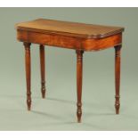 A Regency mahogany turnover top tea table, with rounded corners and raised on turned tapered legs.