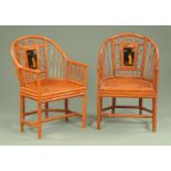 A pair of chinoiserie lacquered armchairs, with panelled backs and bergere seats.