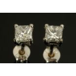 A pair of 18 ct white gold princess cut diamond stud earrings, total diamond weight +/- .60 carats.