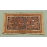 An Eastern rug. 82 cm x 140 cm including fringe.