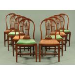 A set of eight Georgian style mahogany dining chairs, having an arched backrest with pierced splat,