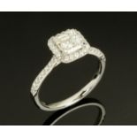 An 18 ct white gold halo ring set with an asscher cut diamond to centre, total diamond weight +/- 1.