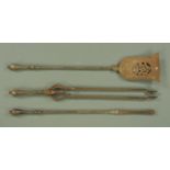 A good set of three early 19th century steel fire irons, the shovel with pierced decoration,