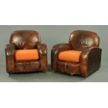 A pair of brown leather upholstered armchairs, with loose cushions and raised on castors,