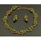 A costume jewellery necklace set with cabochons, together with a pair of ear clips.