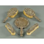 A five piece silver backed dressing table set, four brushes and a mirror, Chester 1909.