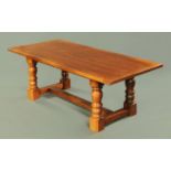 A large oak refectory table, raised on turned legs united by centre and end stretchers.