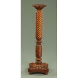 A Victorian mahogany bedpost torchere, with circular top and shaped quatreform base. Height 115.
