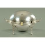 An Edwardian silver plated breakfast warming dish, with rollover top and raised on four legs.